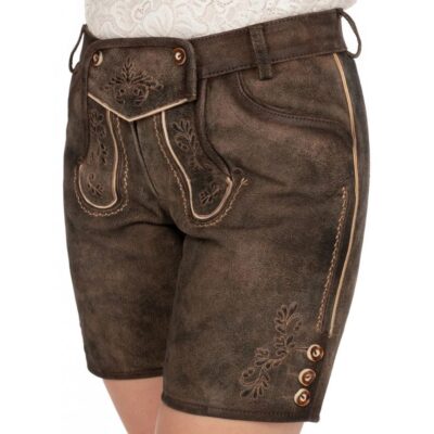 Woman wearing dark brown suede lederhosen shorts featuring traditional beige embroidery, decorative flap with buttons, and buttoned side leg detail.