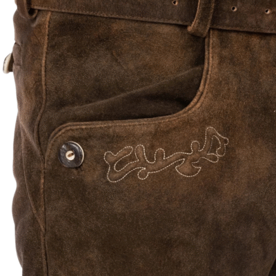 Close-up of pocket on brown suede lederhosen with traditional embroidery and button
