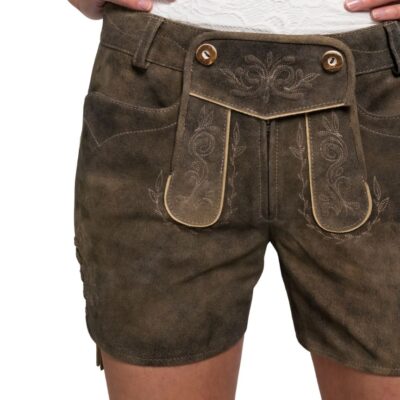 Close-up front view of women's brown lederhosen shorts featuring ornate cream embroidery on the flap and thighs, with decorative horn buttons.