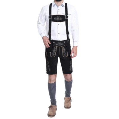 Full-body view of a man wearing a traditional Bavarian lederhosen outfit including a white shirt, black embroidered shorts with suspenders, gray socks, and tan shoes.