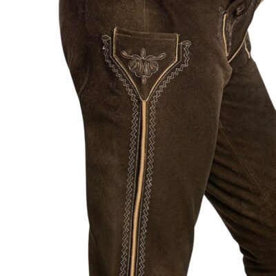 Close-up side view of dark walnut lederhosen showing ornate embroidery around the side pocket and along the outer thigh seam, with zigzag stitching and beige piping.