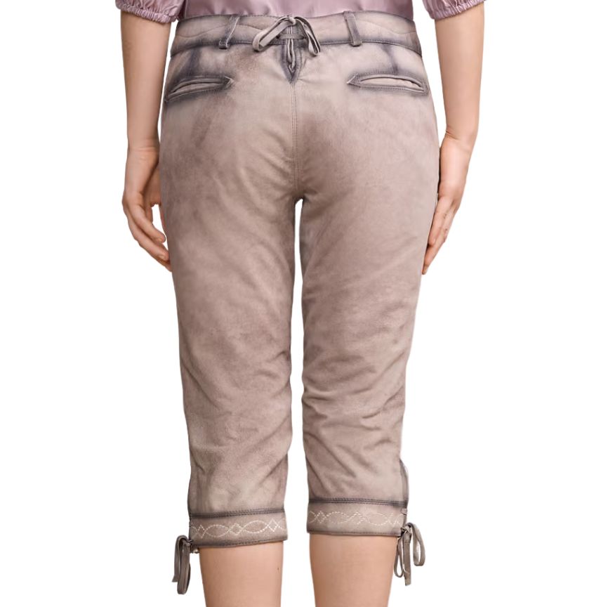 Woman wearing beige knee-length leather lederhosen with decorative stitching on the cuffs and lace-up detail at the back waistband.