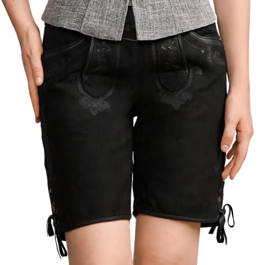 Front view of women’s black Bavarian leather shorts showcasing symmetrical tonal embroidery, deep front pockets, and lace-tied slits at the hem. SchwarzTrachten Lederhosen