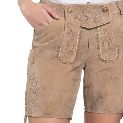 Close-up of front embroidery on tan women's lederhosen, highlighting traditional Bavarian floral patterns.