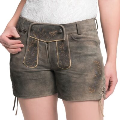 Angled front view of women's olive brown lederhosen shorts, with embroidered flap, leaf pattern accents, and lace-up sides reflecting a classic Bavarian design.
