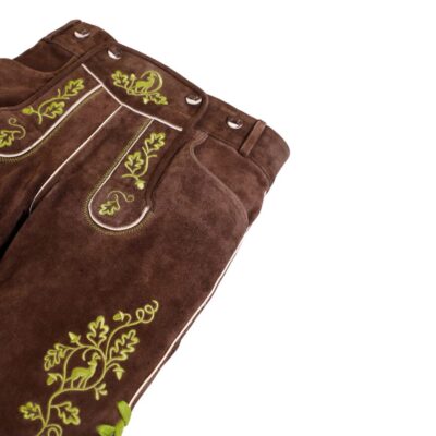 Flat lay of Bavarian lederhosen with oak leaf embroidery and forest-themed detailing